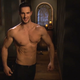 A drunk contestant takes his shirt off and flexes for the camera.